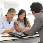 Couple Signing Mortgage Documents